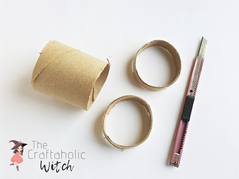 Toilet paper roll cut into rings with a craft knife to make the concrete mold for a wire picture holder
