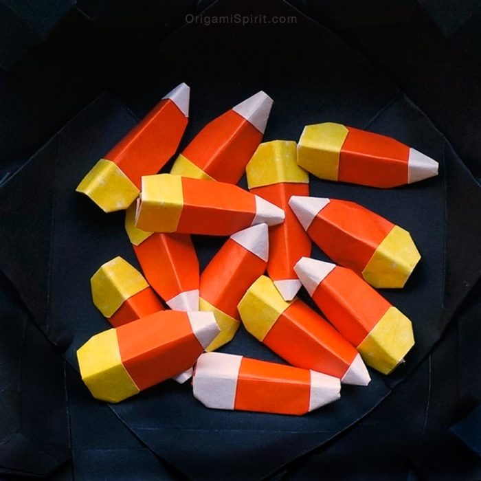 15 Halloween Origami Projects with Step-by-Step Tutorials 6 Origami candy corn: small folded paper candy corn pieces in orange and white
