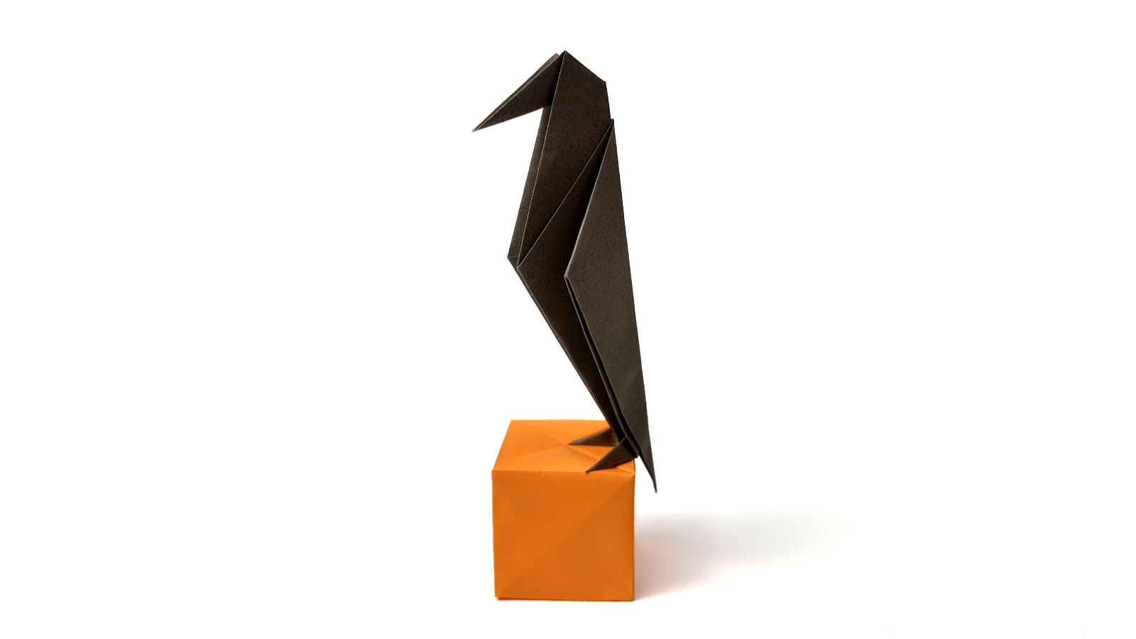 15 Halloween Origami Projects with Step-by-Step Tutorials 10 Origami crow: standing black paper bird with folded beak and tail