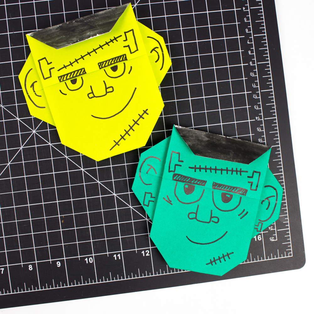 15 Halloween Origami Projects with Step-by-Step Tutorials 16 Origami Frankenstein: green paper face with drawn bolts, stitches, and flat brow