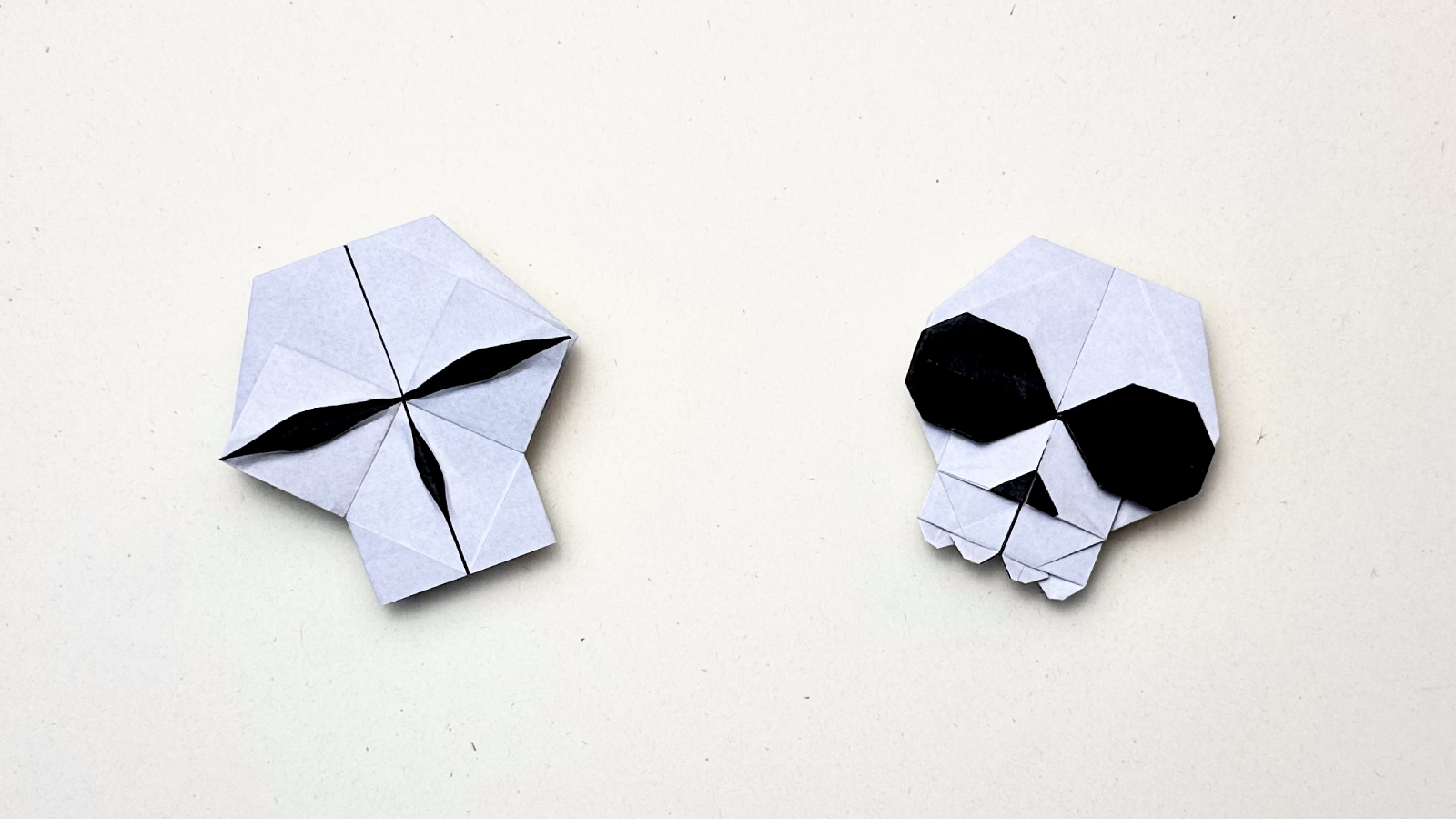 15 Halloween Origami Projects with Step-by-Step Tutorials 9 Origami skull: white paper skull with dark eye sockets revealed by color-change fold