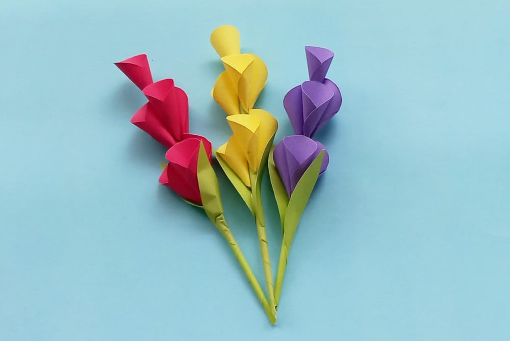 18 Best DIY Construction Paper Crafts (With Full Tutorials) 12 Construction paper flowers with rolled cone petals on paper stems