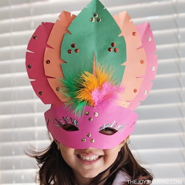 18 Best DIY Construction Paper Crafts (With Full Tutorials) 9 Decorated construction paper mask with cut out eyes and colorful trim