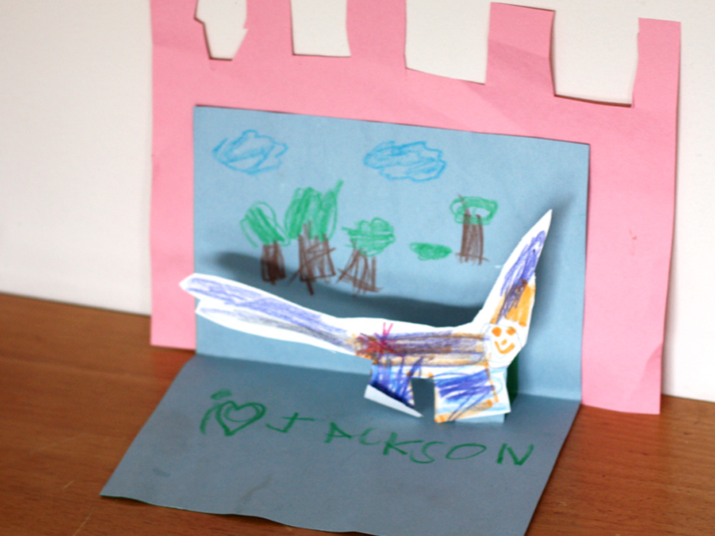 18 Best DIY Construction Paper Crafts (With Full Tutorials) 16 Construction paper pop up card open showing a raised paper cutout