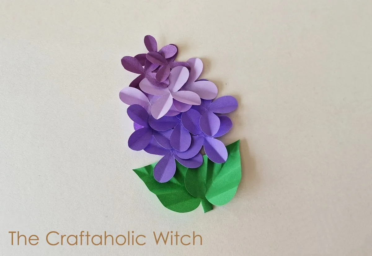 Paper lilac flower craft step 10 Finished paper lilac flower with layered petals and folded green leaves