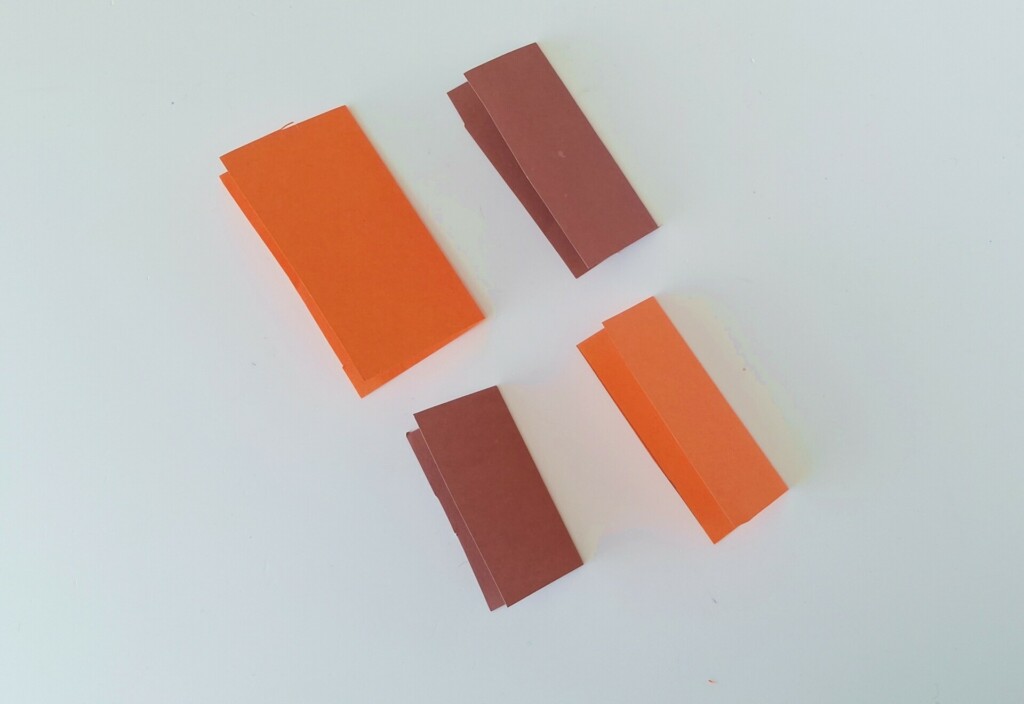 Step 2: Fold the Paper Cutouts in Half