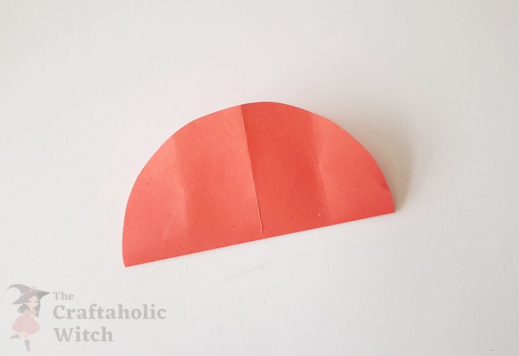 Paper circle with two perpendicular fold lines forming a plus sign for 3D paper heart Valentine's craft