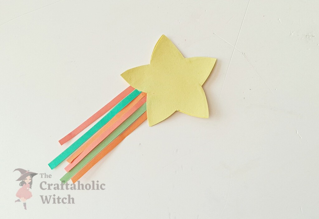 Glue applied around perimeter of paper star leaving opening for pencil on DIY topper