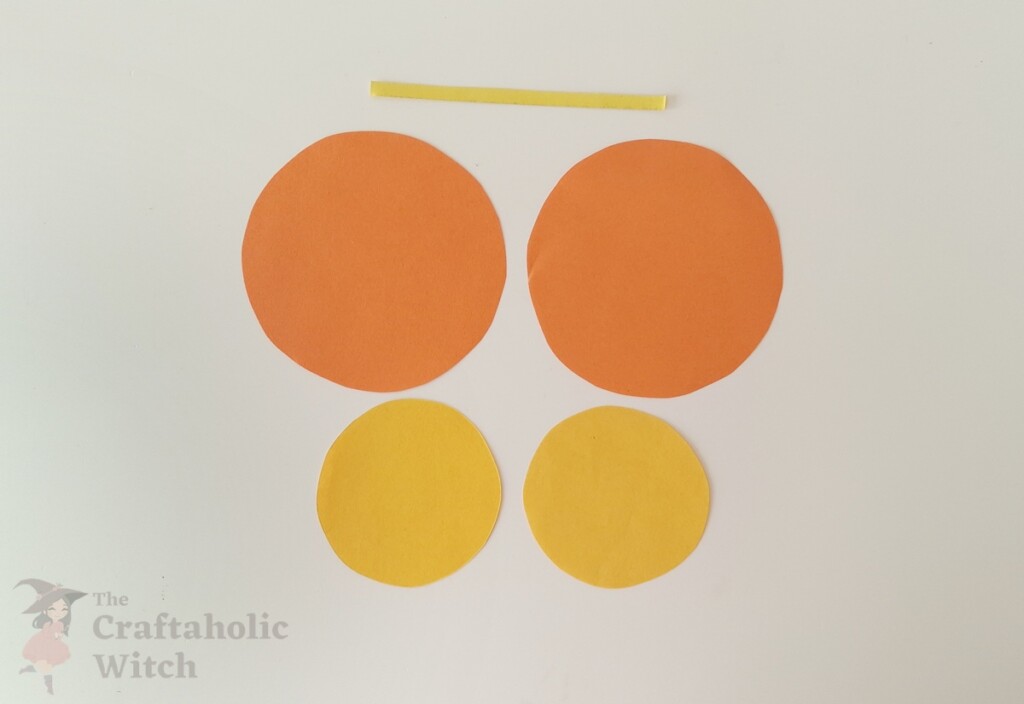 Easiest Paper Butterfly for Kids (with Free Template) 3 Tracing butterfly template pieces onto colored paper with pencil and cutting with scissors