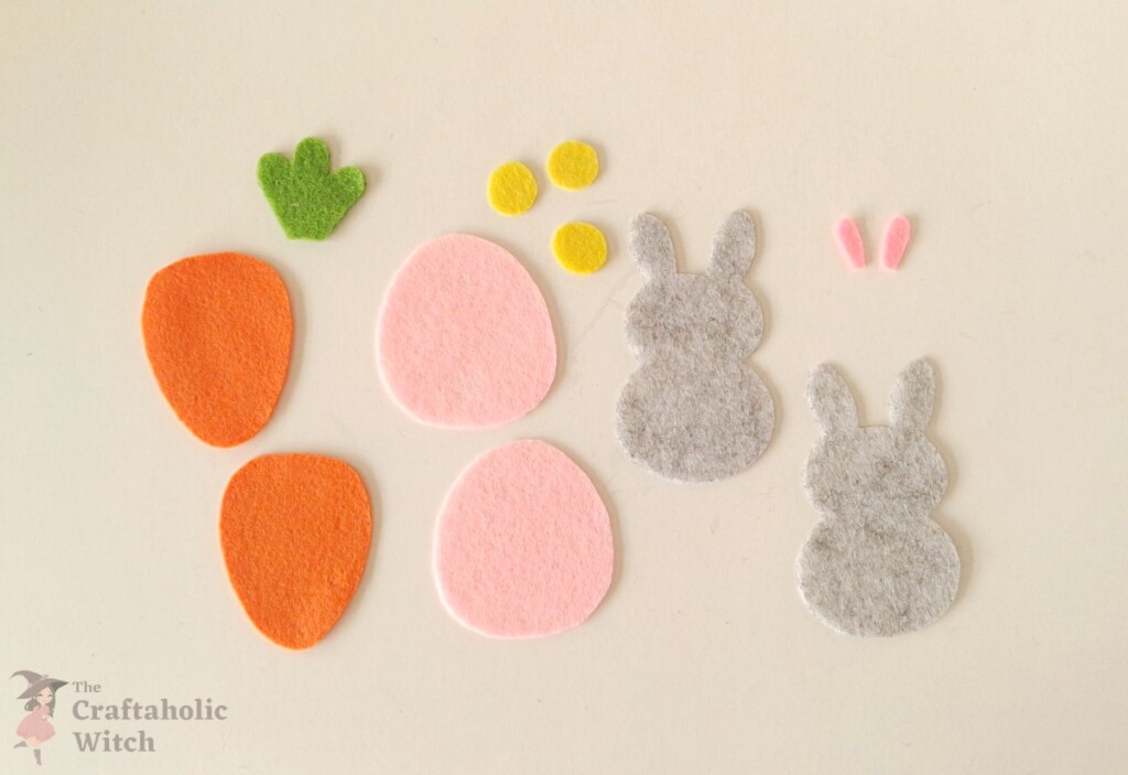 Cutting felt pattern pieces for Easter pencil toppers Felt egg, rabbit, and carrot pattern pieces traced and cut for Easter pencil toppers
