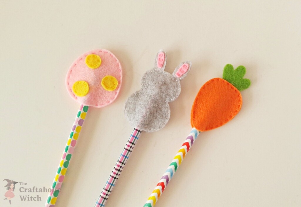 Securing the final stitches Finished felt egg, rabbit, and carrot pencil toppers with thread ends secured