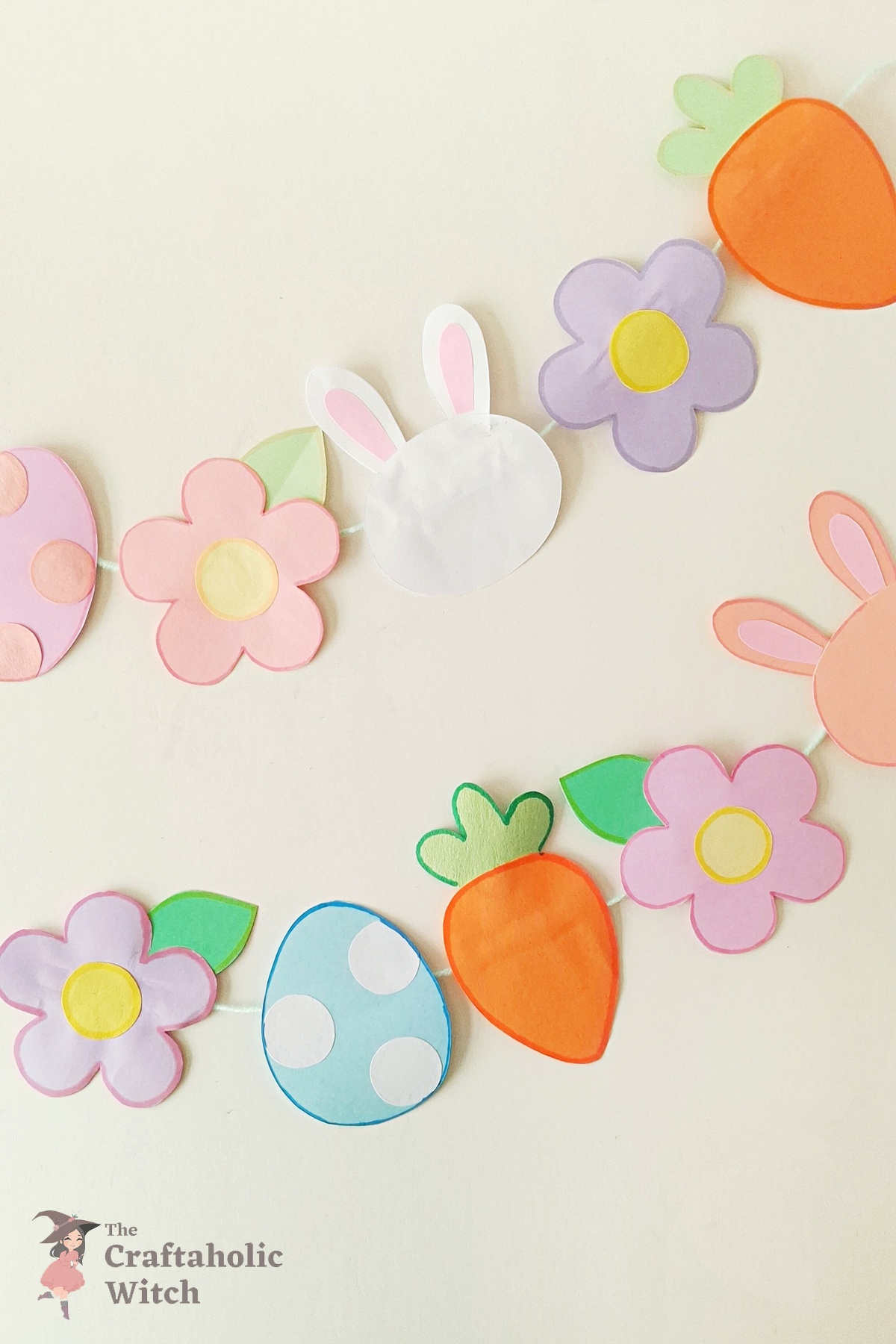 Easter paper garland hanging decorated with handmade bunny egg carrot and flower shapes