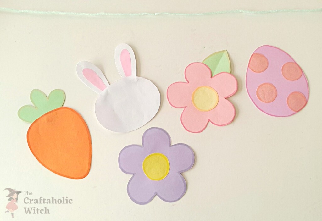 Multiple paper garland pieces outlined with markers in various spring colors