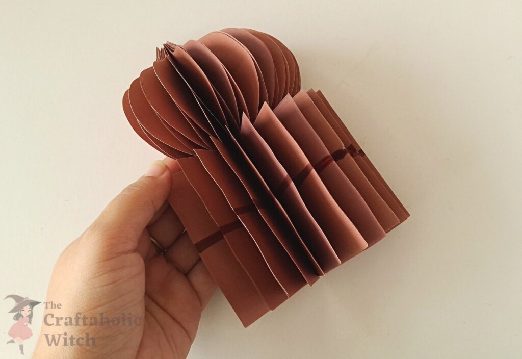 Ramadan decor step 12 - open 3D shape Hands gently opening the layered paper patterns to form the full 3D dome shape