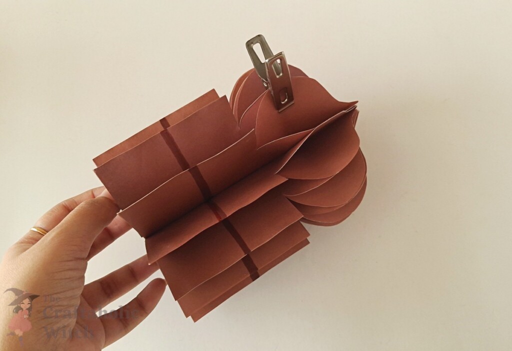 Ramadan decor step 14 - secure join Clothespin holding the final glued joint of the 3D paper Ramadan decor while it dries