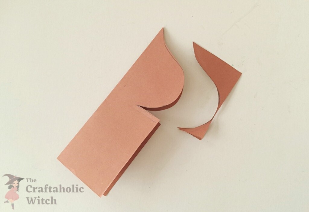 Ramadan decor step 4 - cut pattern Scissors cutting along the traced dome pattern on a folded craft paper sheet