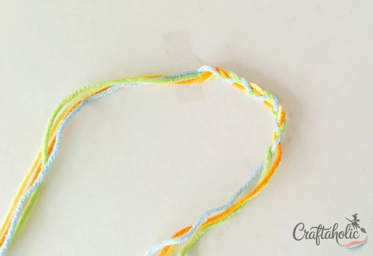 Braiding the middle section of the braided friendship bracelet