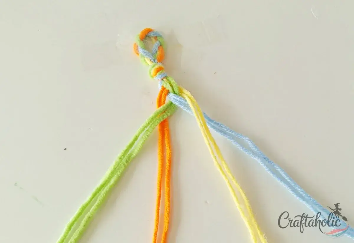 Continuing the four-strand braid of the friendship bracelet