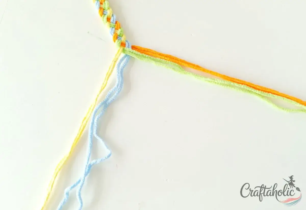Dividing the strands into two groups to make the bracelet closure