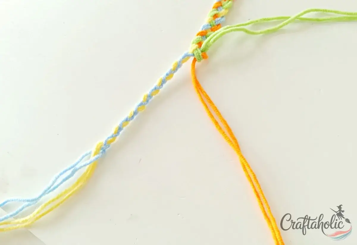 Braiding the left group of strands for the bracelet tie