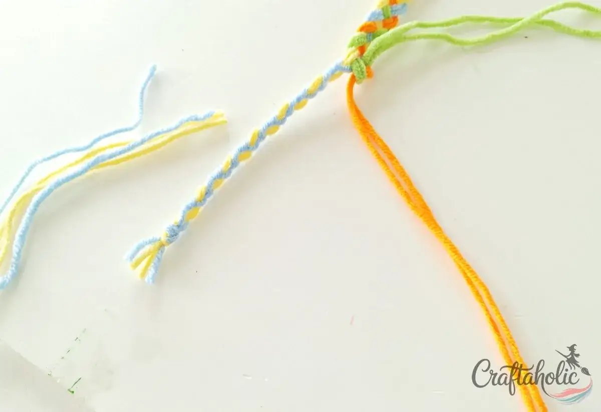 Tying a knot to secure the braided tie and trimming the ends