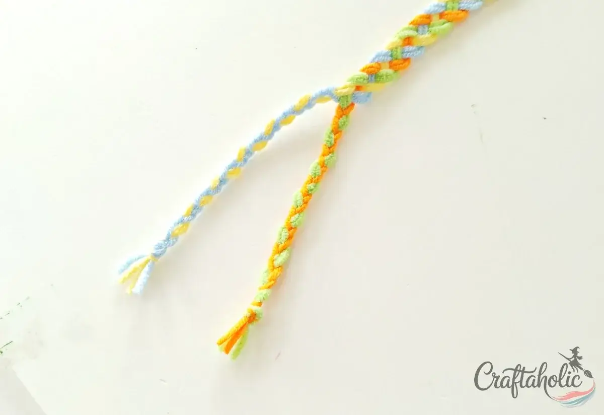 Braiding the right group of strands for the second bracelet tie