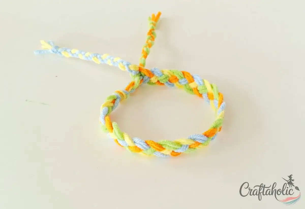 Closing the braided friendship bracelet with a simple tie
