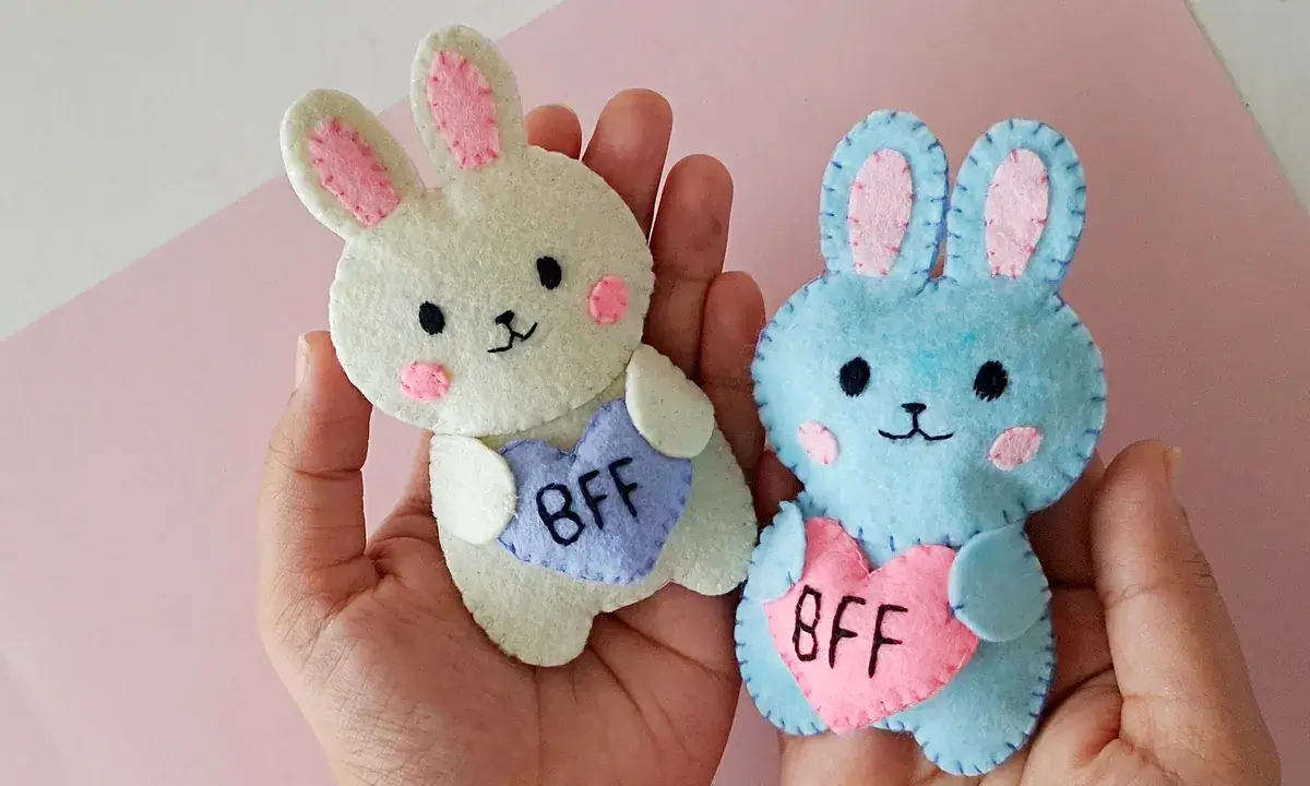 Finished felt BFF bunny plush pair Two finished felt bunny plush toys, one cream and one blue, each holding a BFF heart