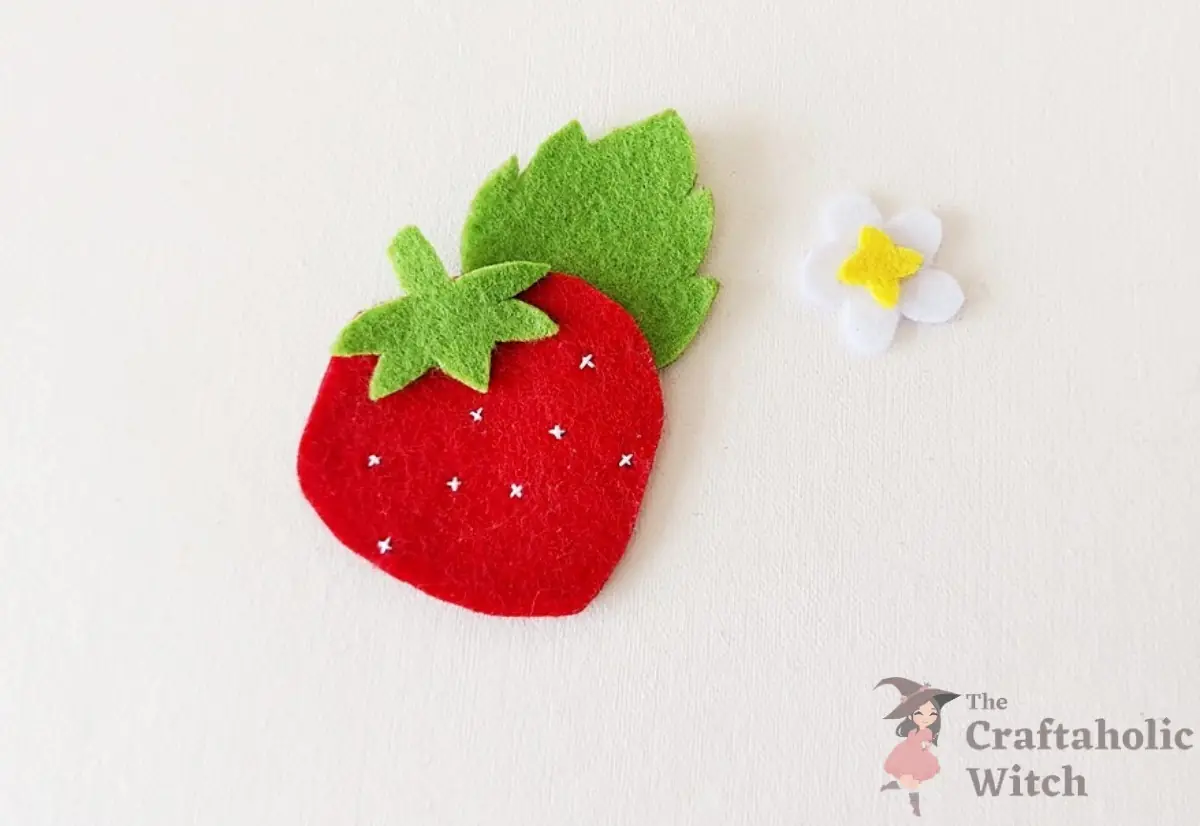 Front and back strawberry felt layers stacked with green top pieces in place