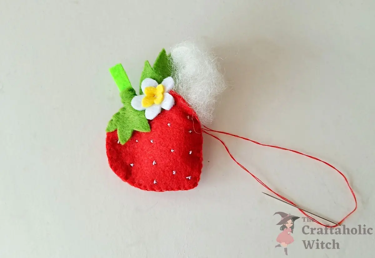 Blanket stitching worked around the strawberry edge with a gap left for stuffing