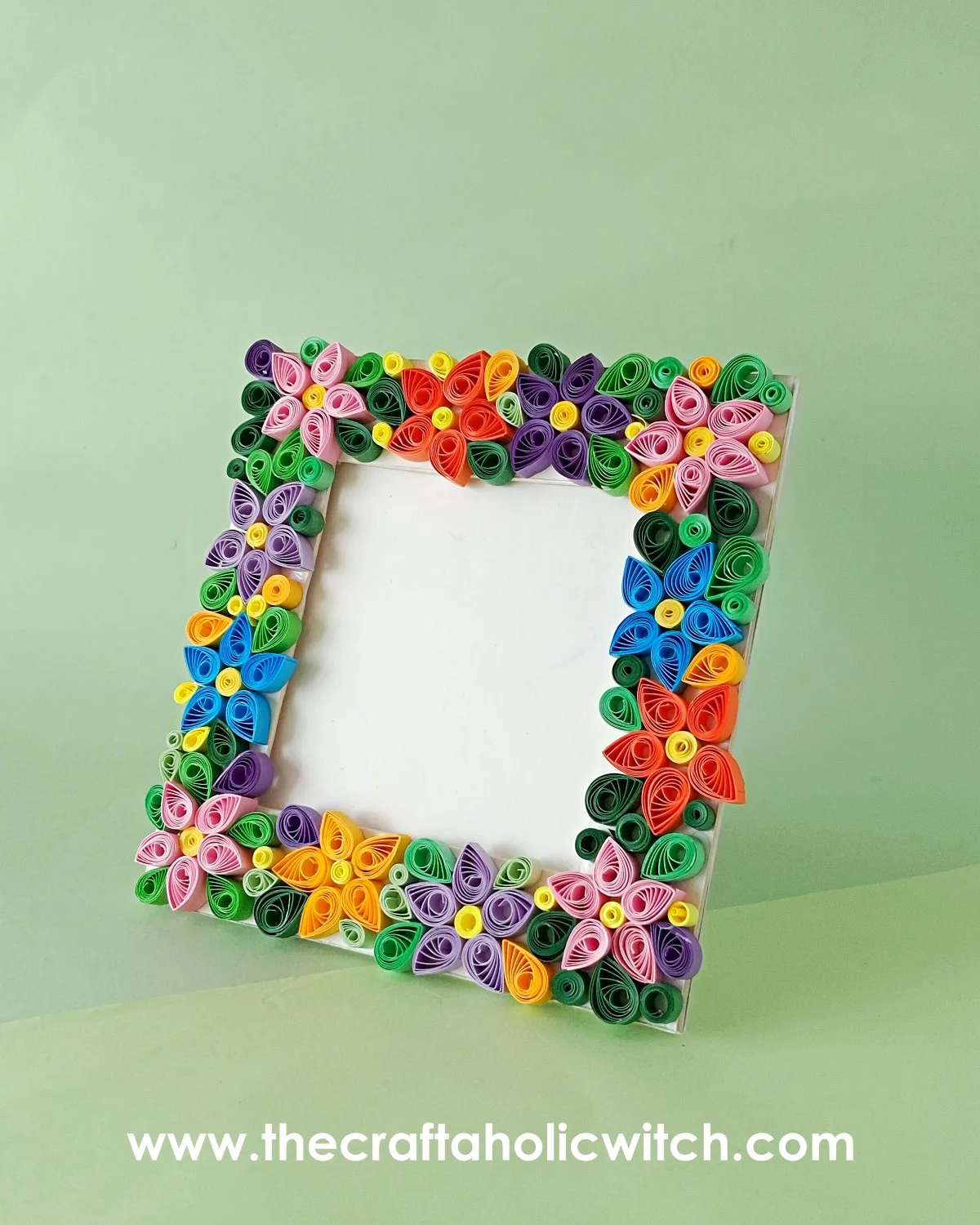 Finished paper quilling photo frame Finished paper quilling photo frame decorated with colorful quilled flowers standing upright
