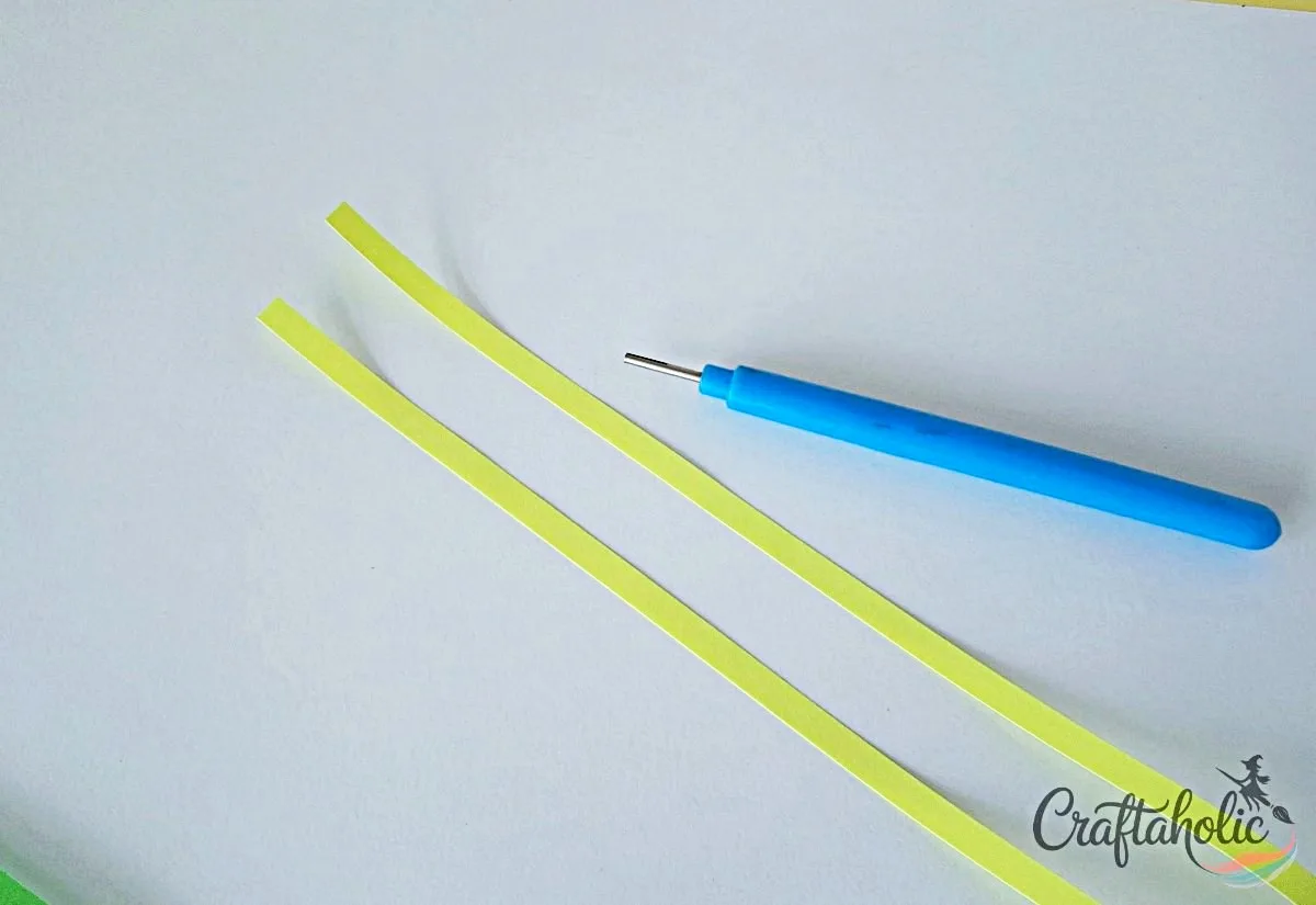 Gather quilling strips and tool Gathering colorful quilling strips and a quilling tool for the photo frame