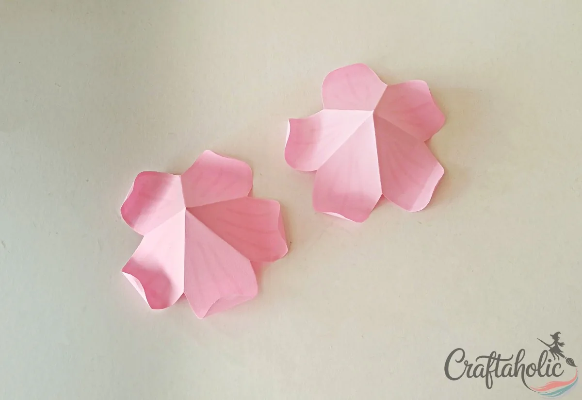 Curling the rounded ends of the flower roof petals with a small round object