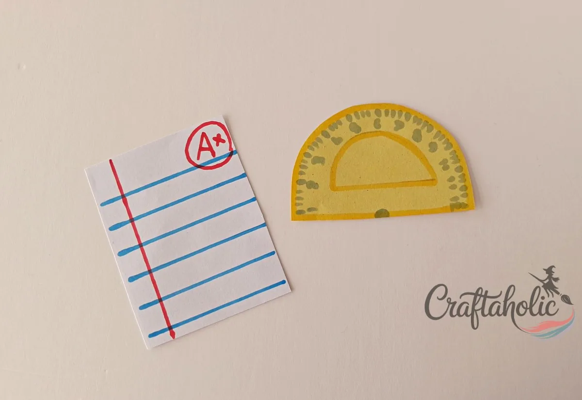 Drawing the notebook page and ruler details Tracing lines and numbers on paper cutouts to make the notebook page and ruler pieces