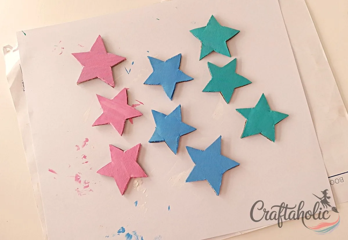 Painting the cardboard stars for the reward jar Painting the cardboard star cutouts for the reward jar craft