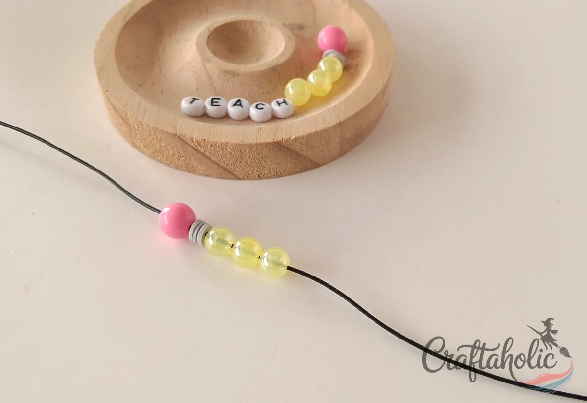 Threading the first beads onto the cord Starting to string beads onto the cord for the bracelet