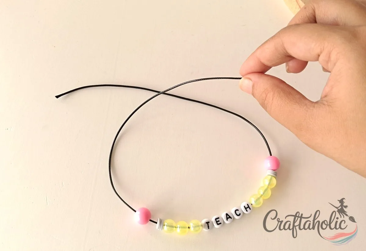 Crossing the cord ends Bringing beads to the middle and crossing the cord ends over each other