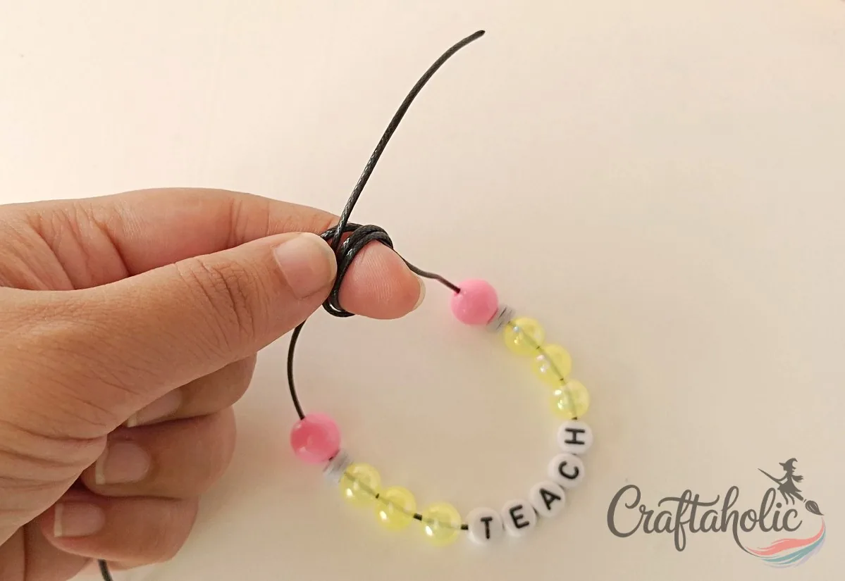 Second wrap around the holding finger Wrapping the left cord around the finger a second time