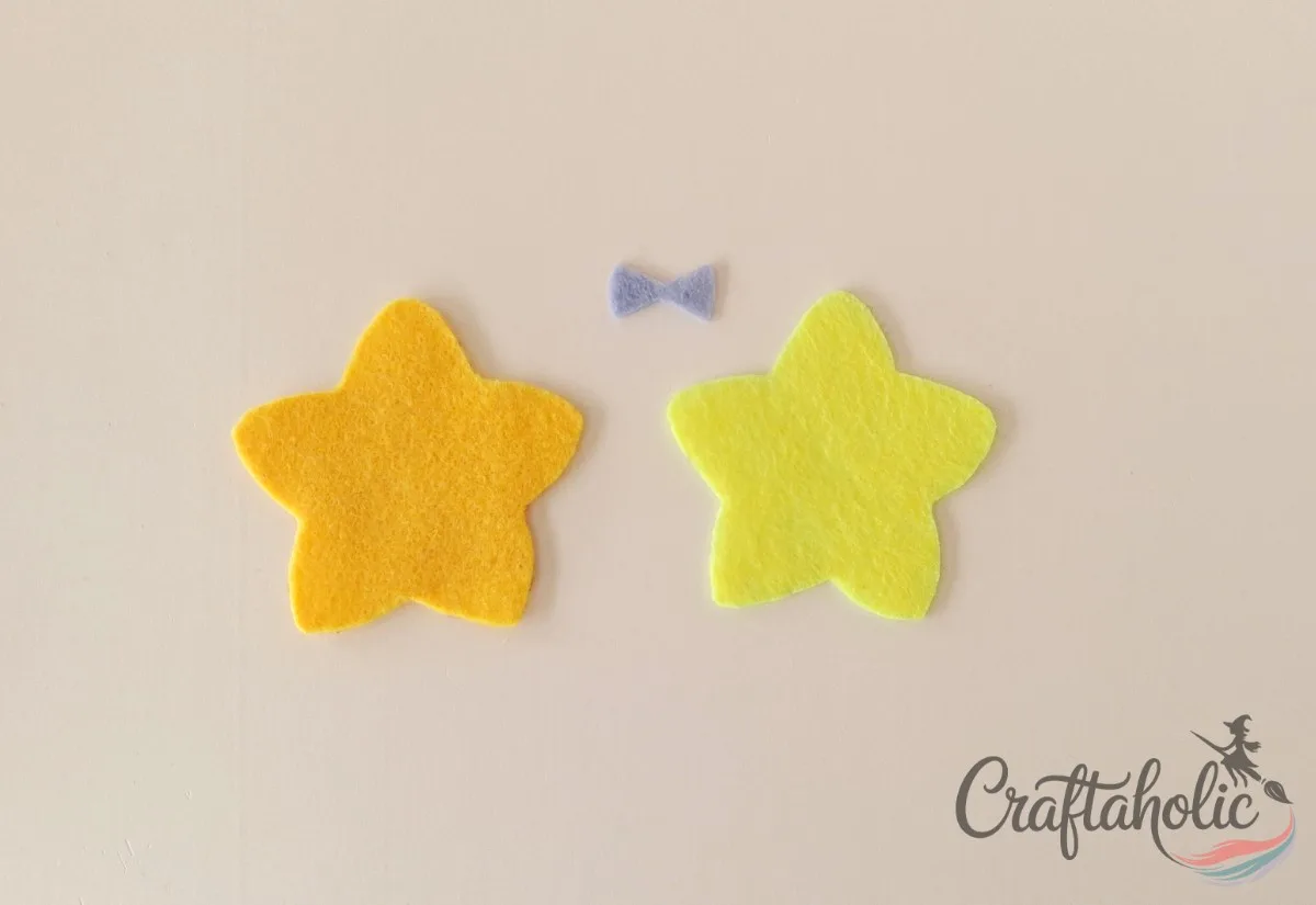 Felt star and bow pattern pieces traced and cut for pencil toppers