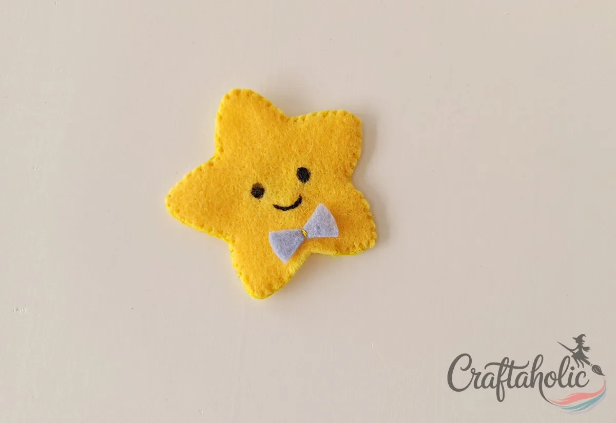Finished felt star pencil topper with bow, ready to slide onto a pencil