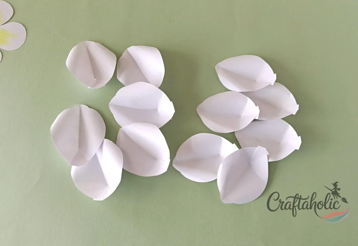 How to Make a Realistic Paper Gardenia Flower 6 Repeating the slit, glue, and curl steps for all large and medium paper gardenia petals