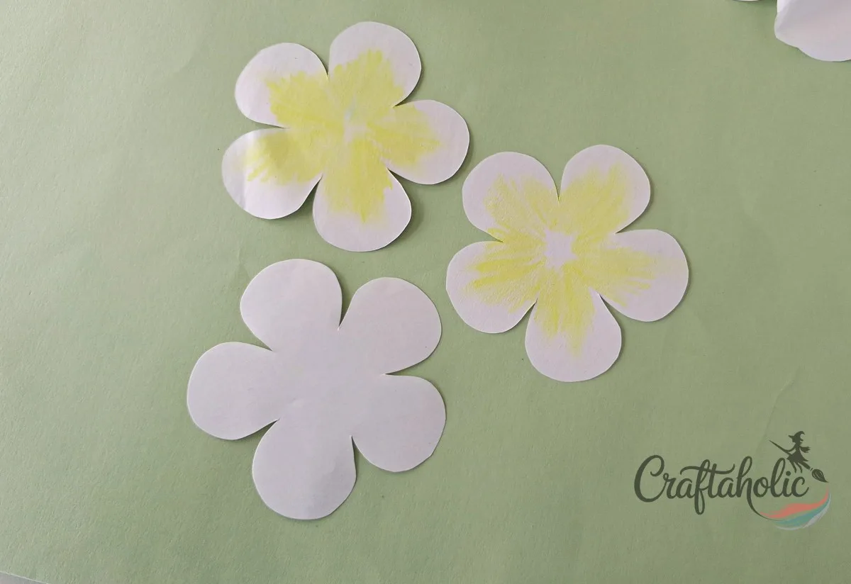 How to Make a Realistic Paper Gardenia Flower 7 Coloring the centers of two paper gardenia petal sets with yellow crayon