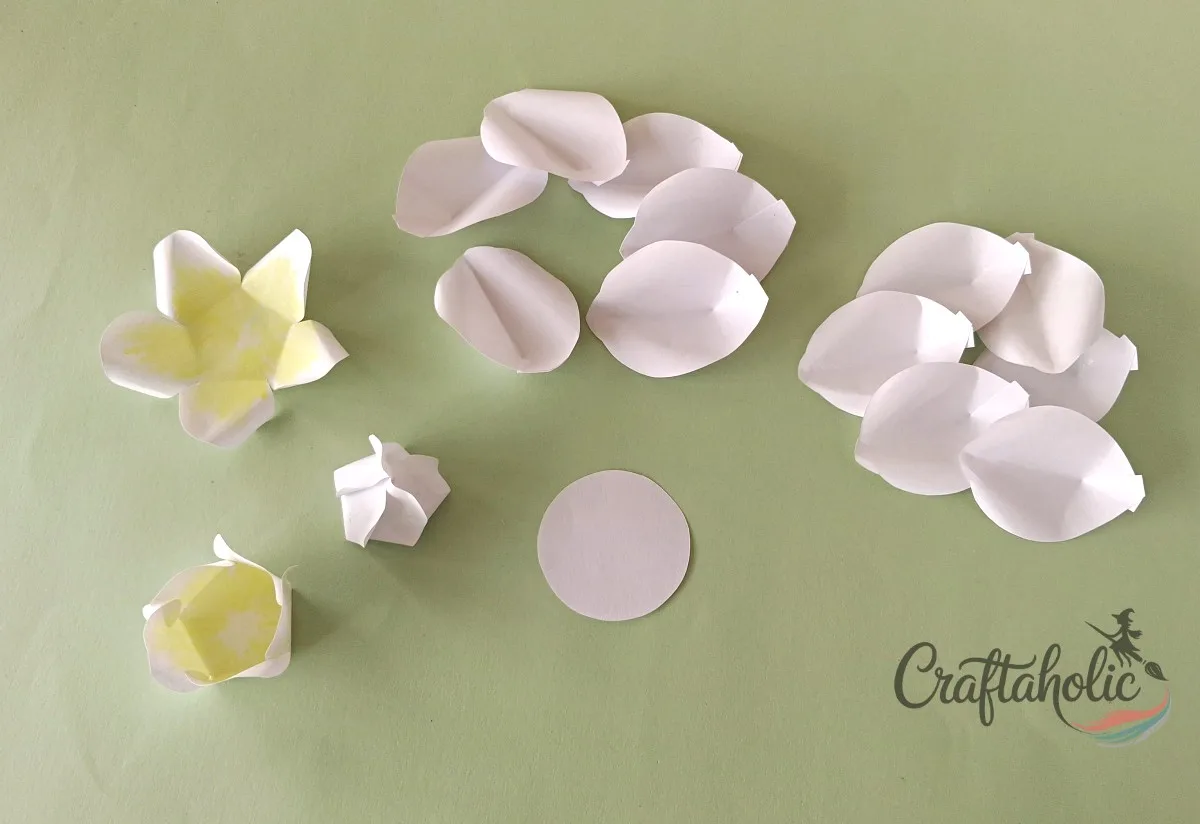 How to Make a Realistic Paper Gardenia Flower 14 Tying off the paper gardenia petal spiral with knots while leaving a topper gap