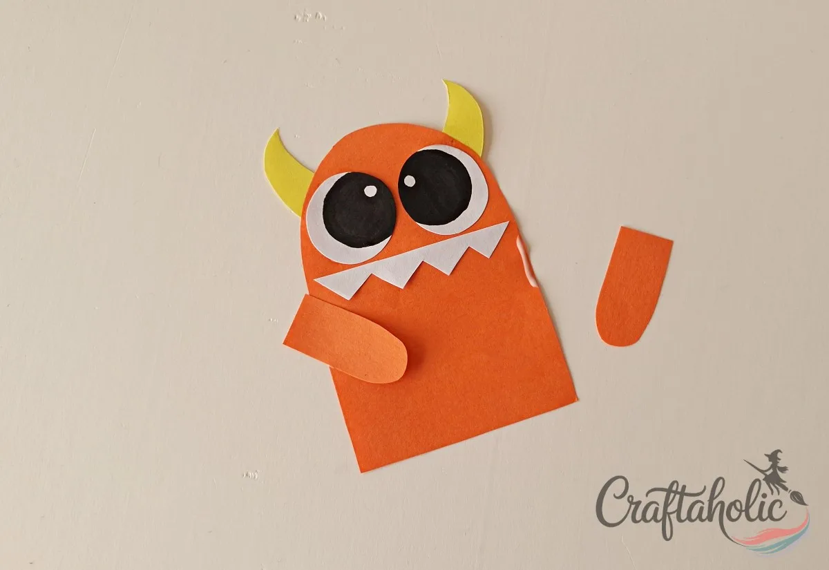 DIY Monster Bookmarks (Easy Paper Craft for Kids) 7 Gluing arm cutouts to the sides of the monster bookmark base