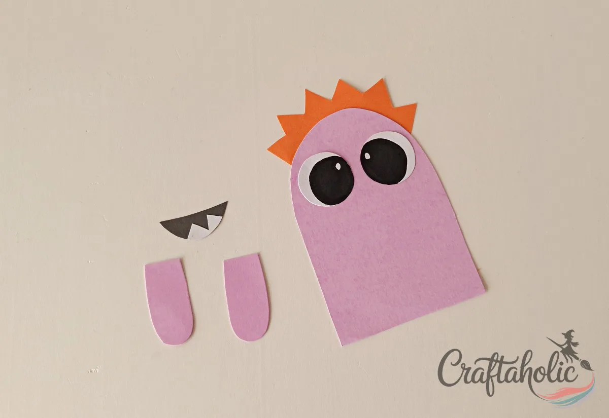 DIY Monster Bookmarks (Easy Paper Craft for Kids) 10 Gluing the eyes to the top of the second paper monster bookmark