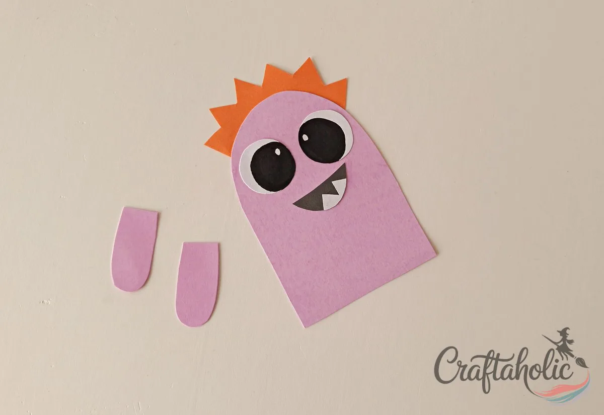 DIY Monster Bookmarks (Easy Paper Craft for Kids) 11 Gluing the mouth pattern below the eyes on the paper monster bookmark