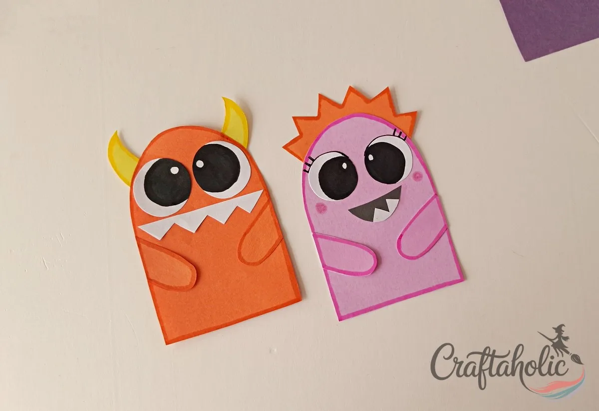 DIY Monster Bookmarks (Easy Paper Craft for Kids) 13 Drawing outlines on the paper monster bookmarks with markers for a finished look