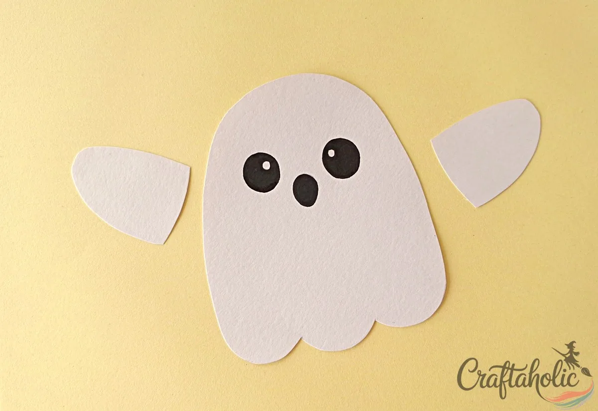 Drawing the ghost puppet face Drawing the ghost's face on the paper ghost body cutout