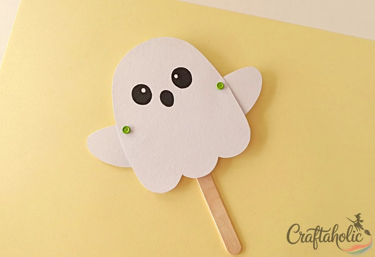 Flipping the puppet to the front side Flipping the ghost puppet to the front side showing the brad pins