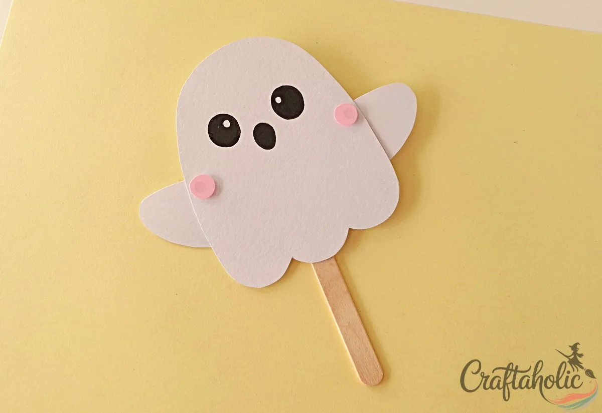 Covering the brad pins with blush circles Covering the brad pins with pink paper circles to make blush cheeks